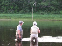 Carol Cherry and guide Gary Colford landing a Salmon
